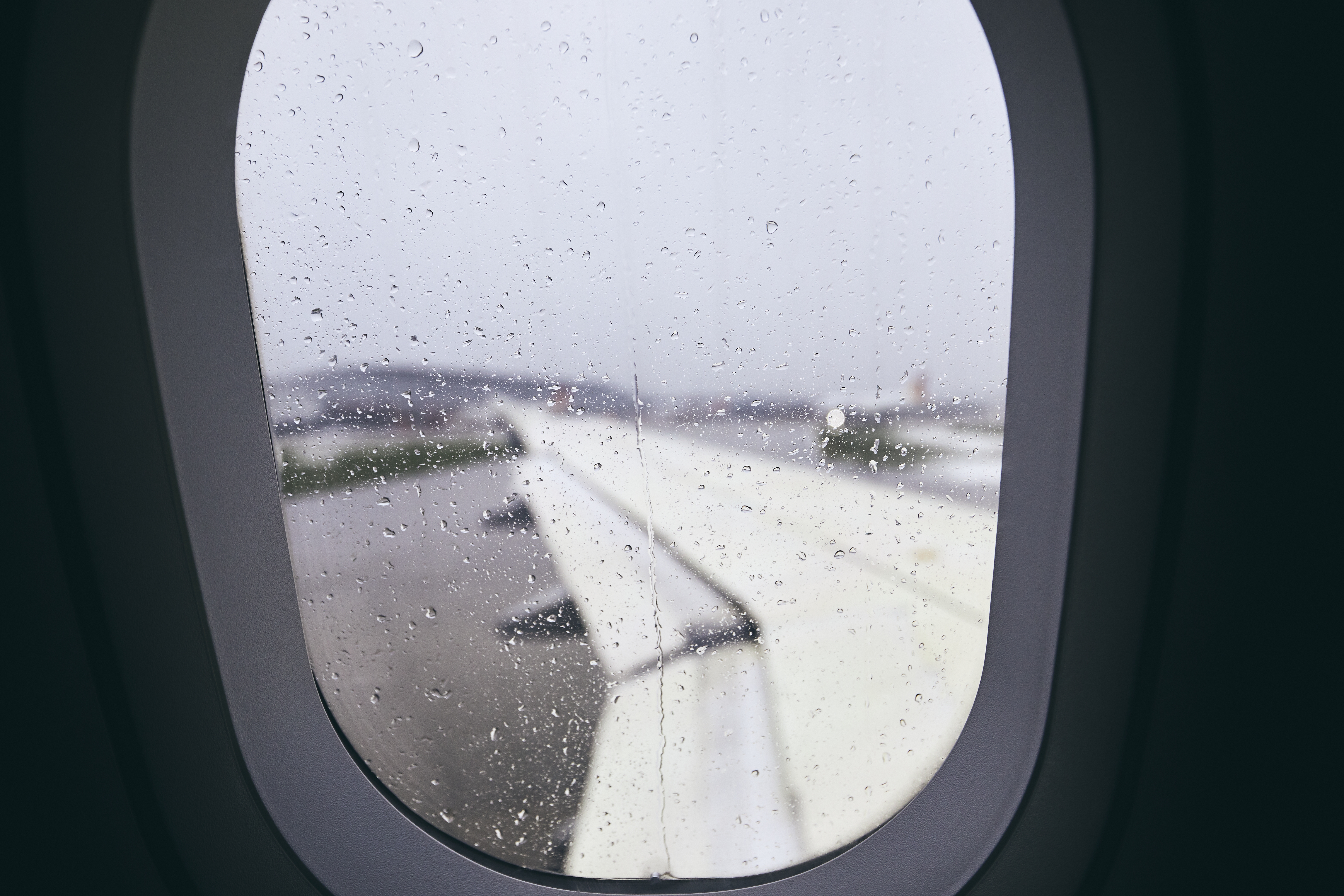 Airplane window during rain